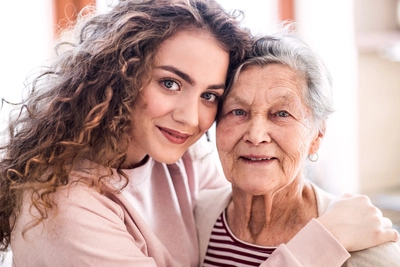 grandmother at home hugging person