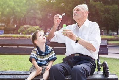 Old man blowing bubbles